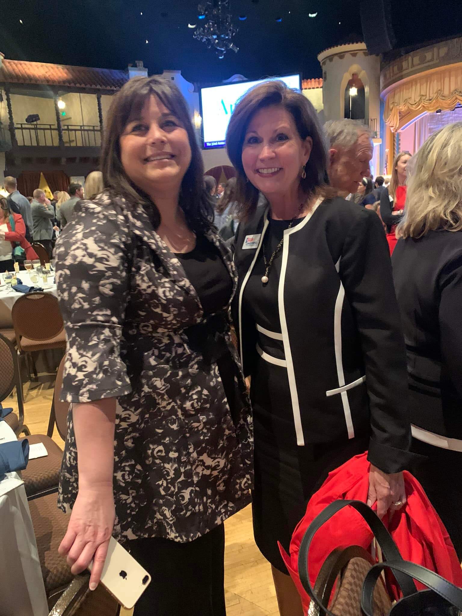 Two Lugar Series members smile – both are wearing black and white