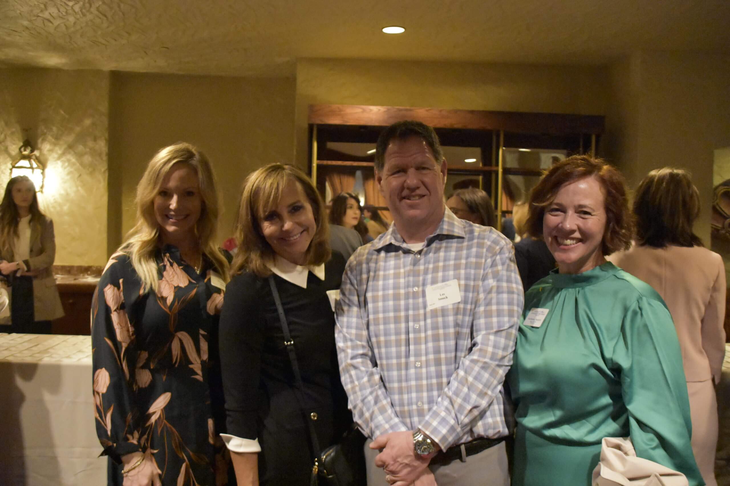 Three event attendees pose together