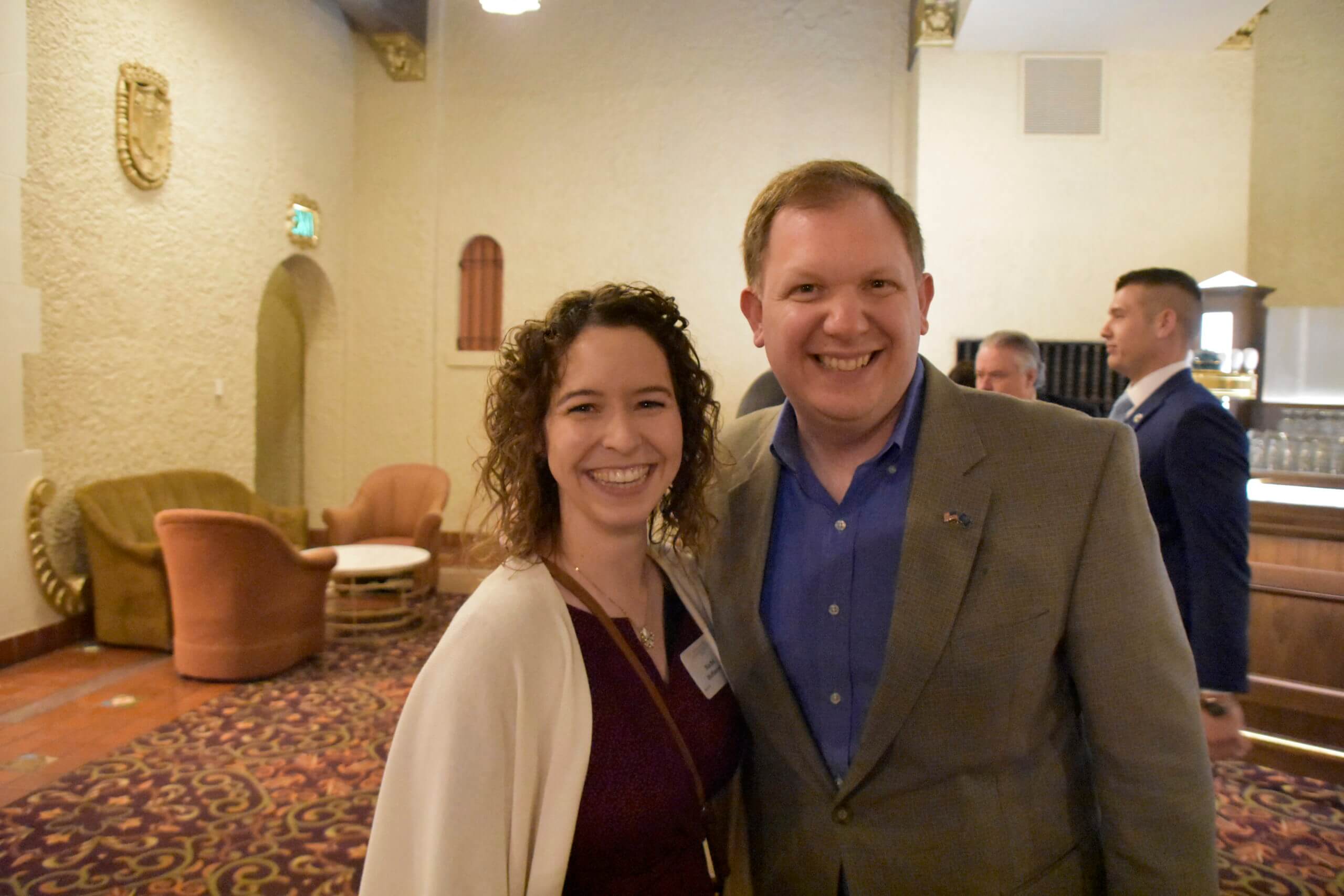 A woman and a man smile together at the Lugar Series event
