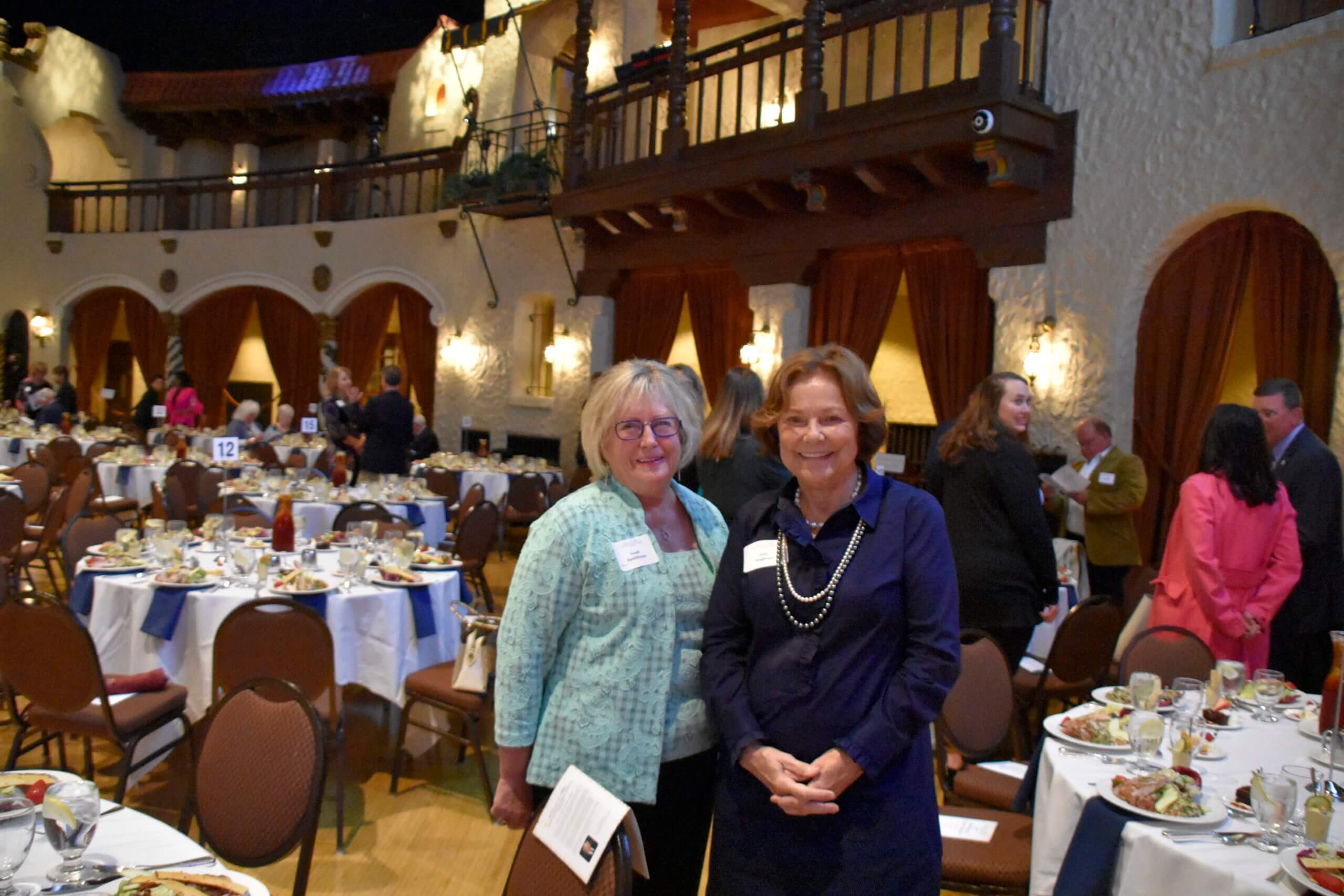 Lugar Series members smile together in the event hall