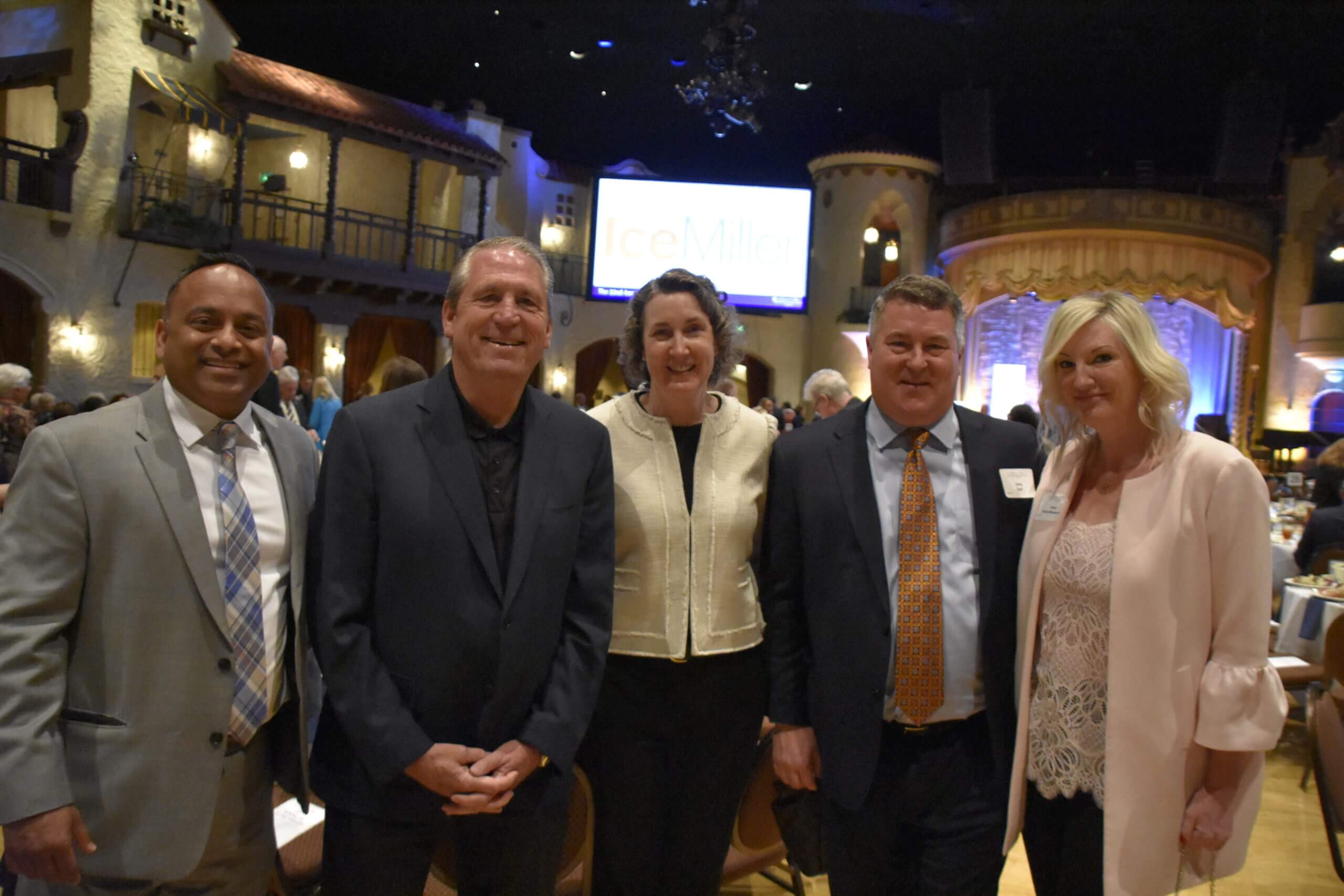 Five people pose together at the Lugar Series event