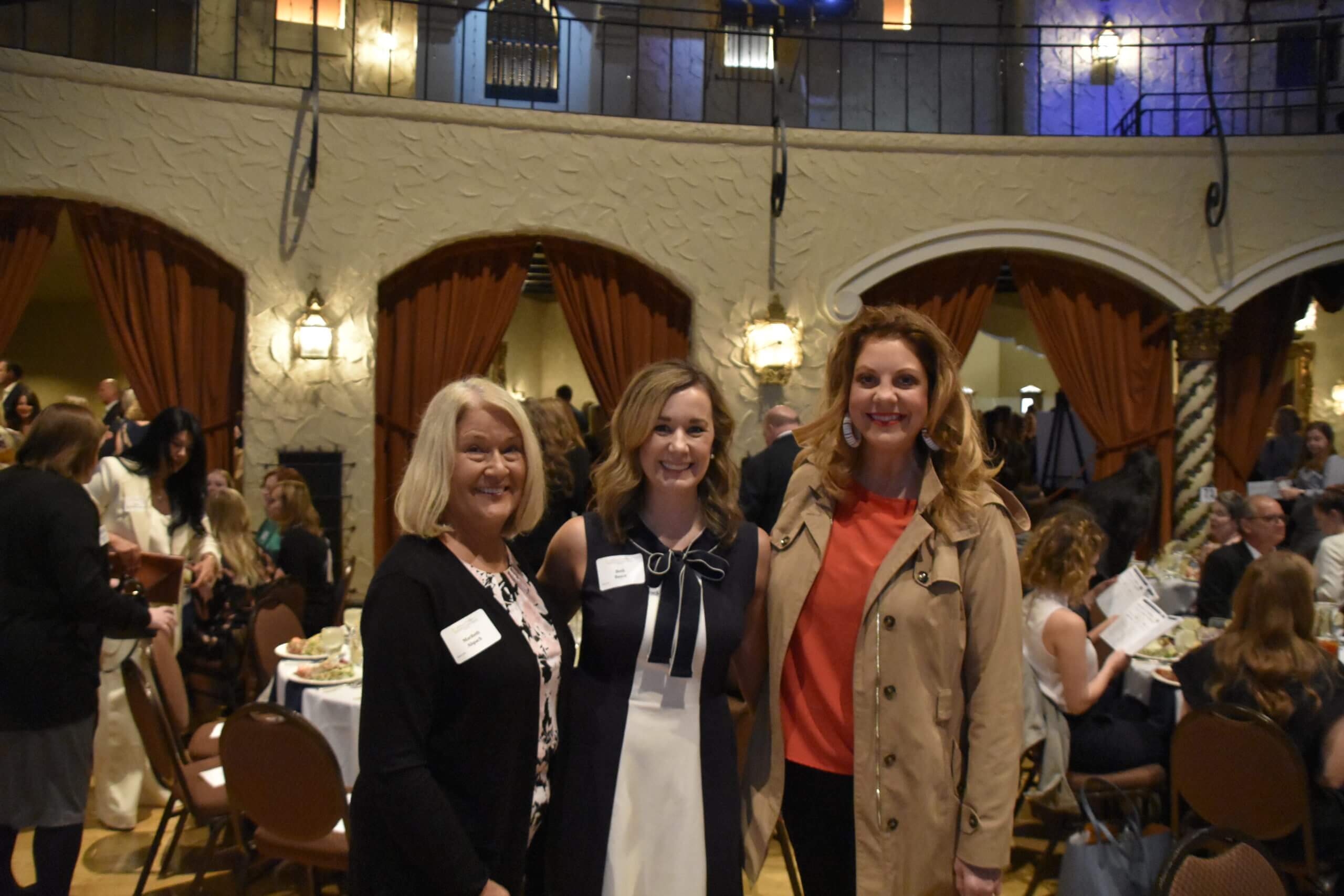 Event attendees smile together and pose for a picture