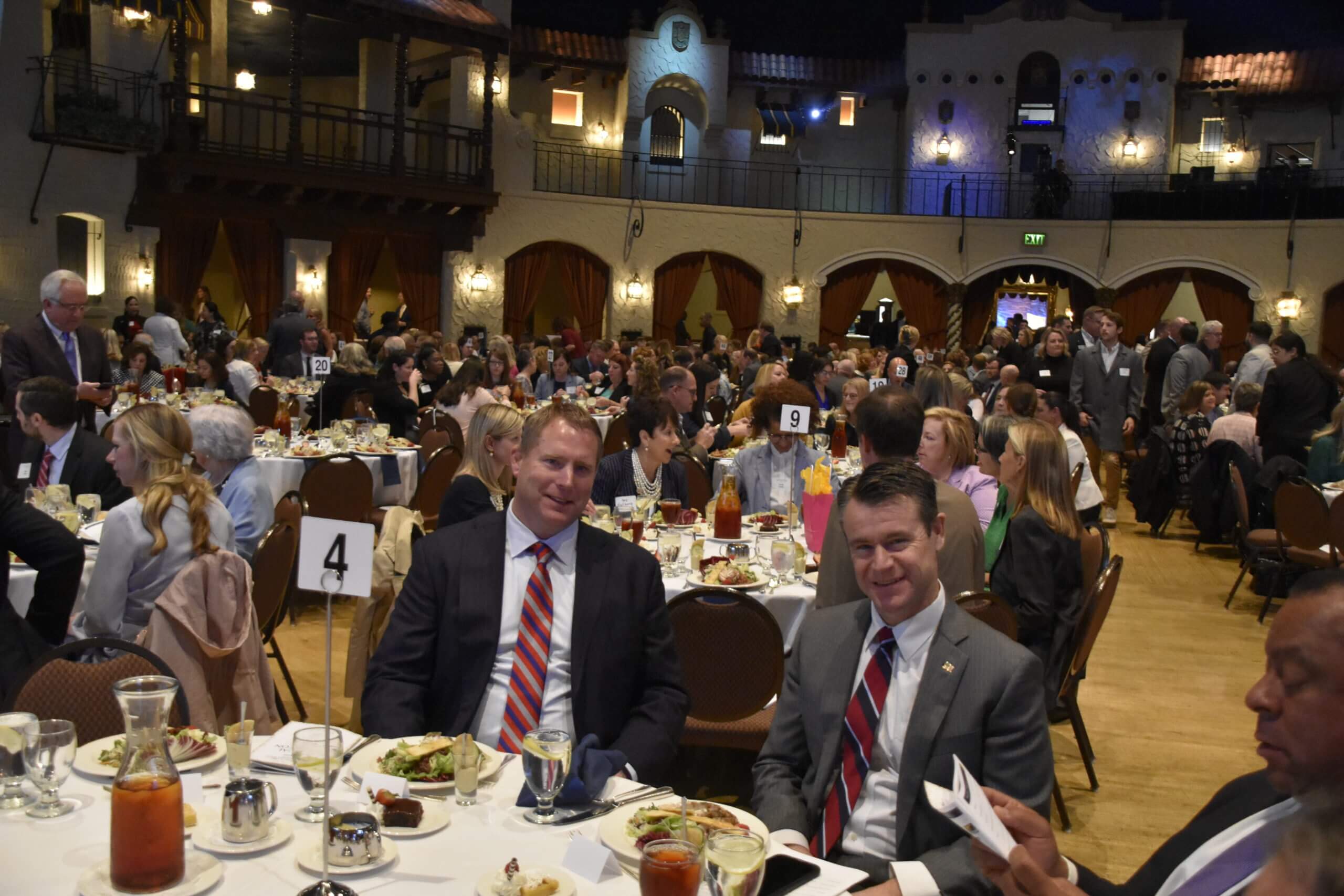 Lugar Series event attendees at their tables, Senator Todd Young sits at his table in the foreground
