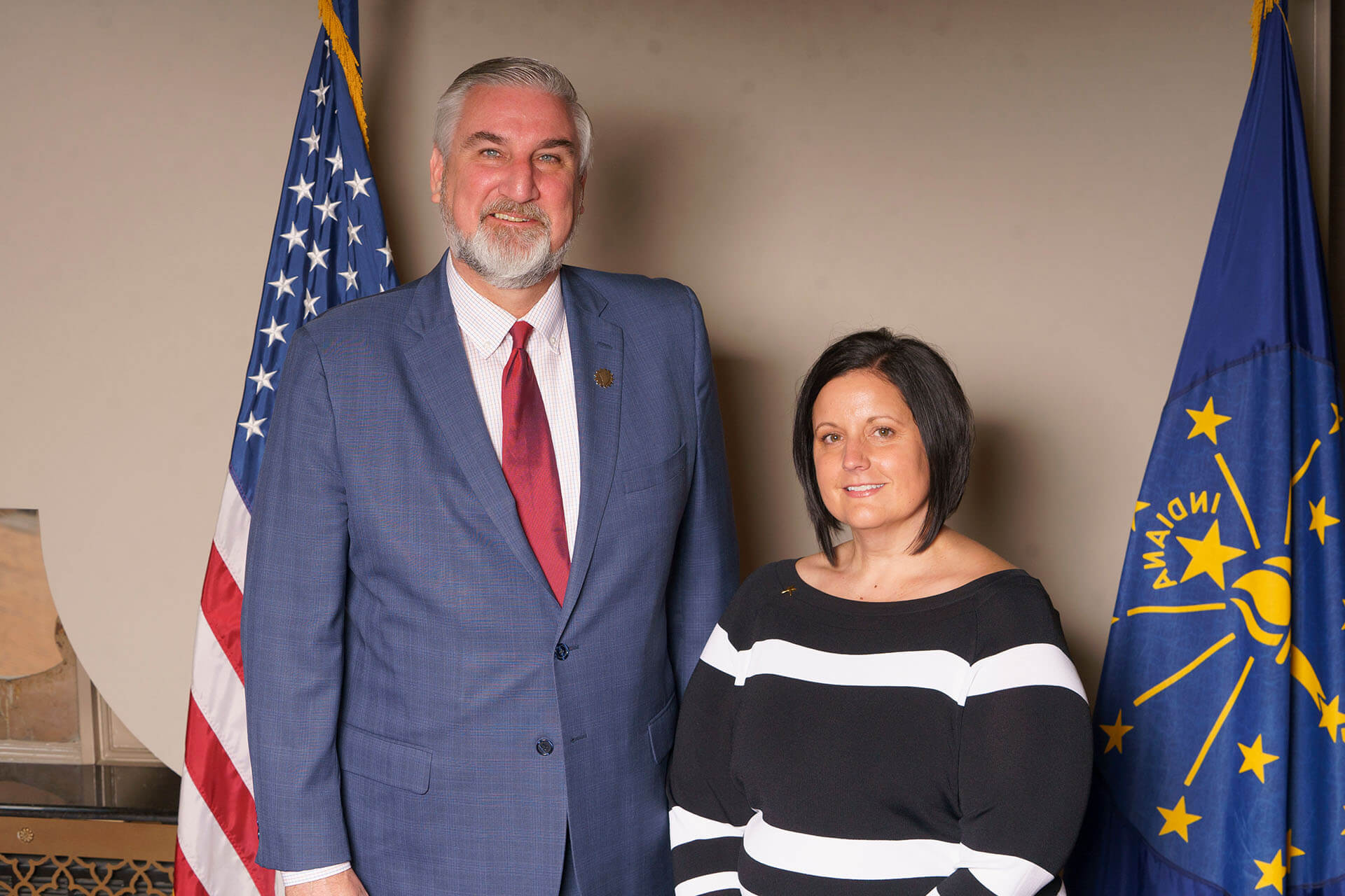 Lugar Series member with a black and white striped shirt, standing with a bearded man