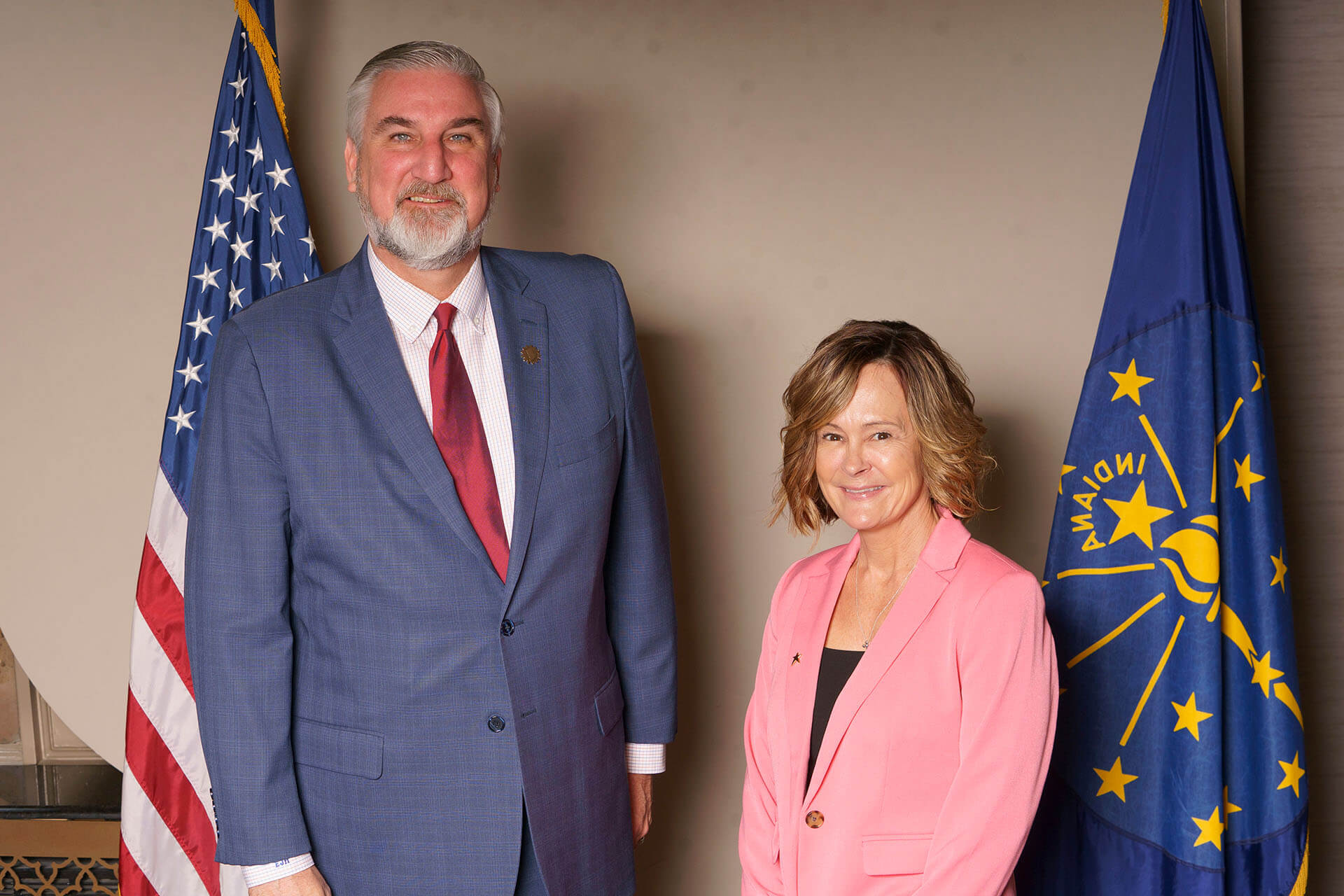 Lugar Series woman with a man in front of a patriotic backdrop