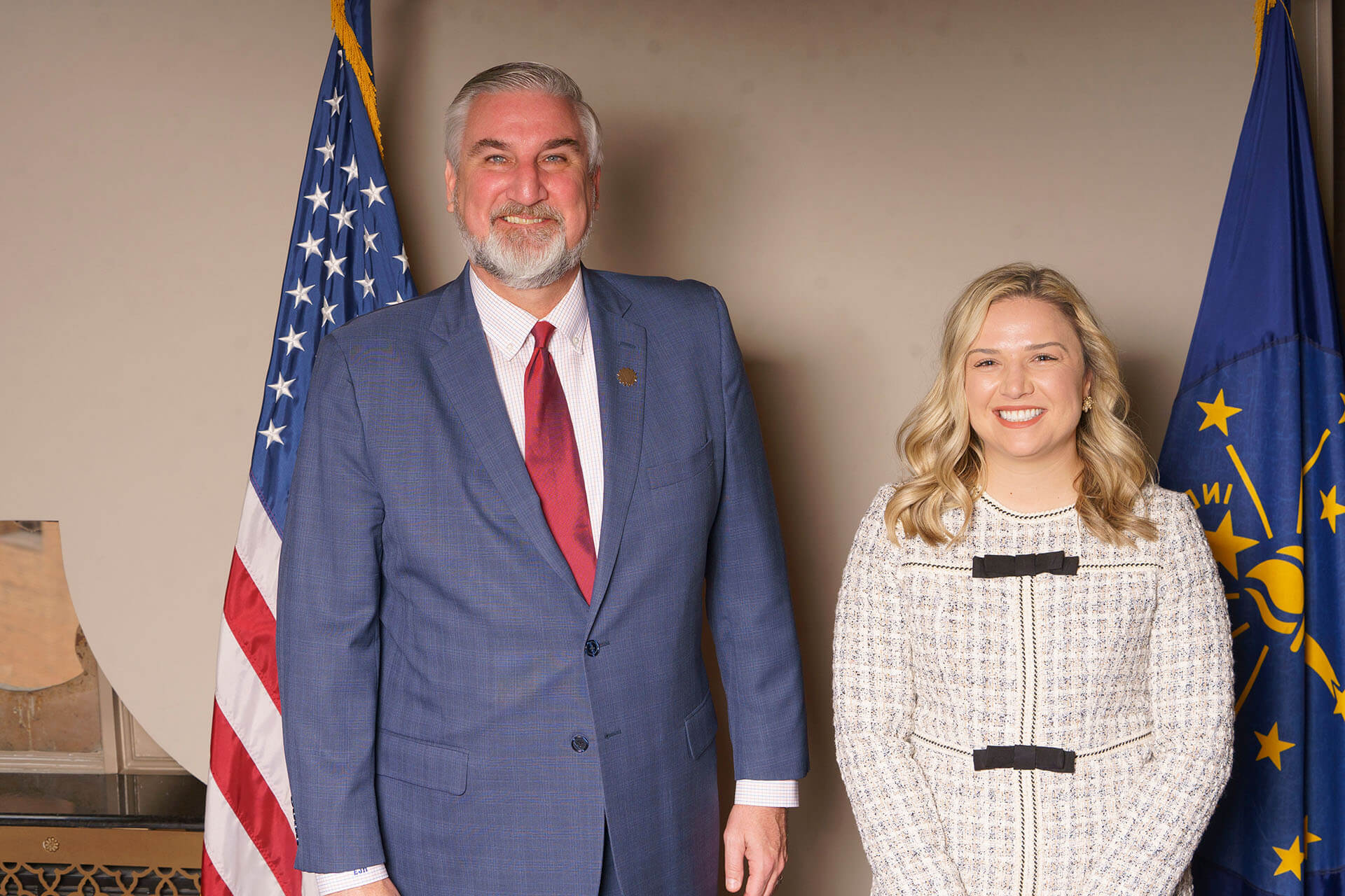 Lugar Series member and man pose with flags behind them