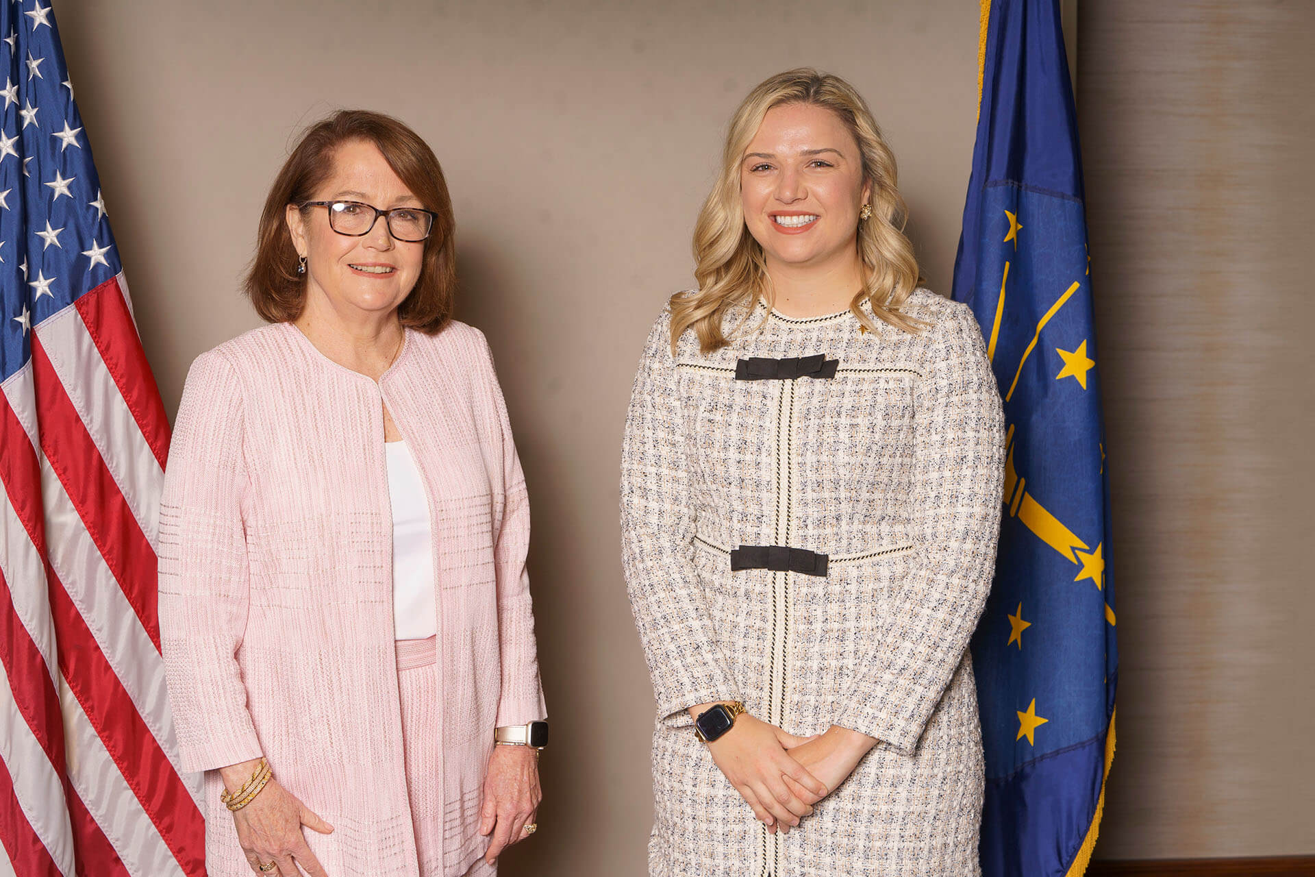 Lugar Series members in front of flags — the woman on the right is blonde