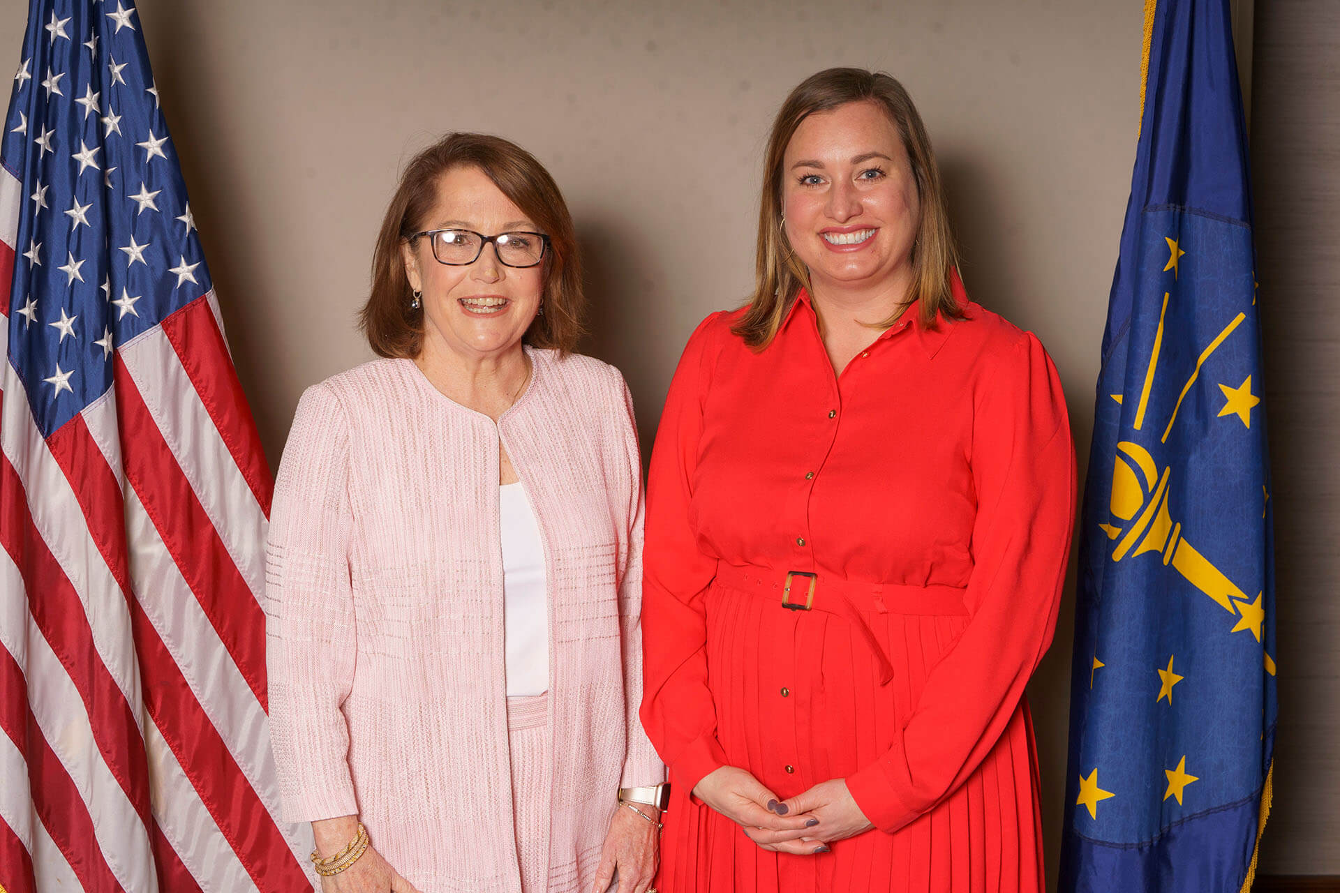 Event photo with two women in front of flags