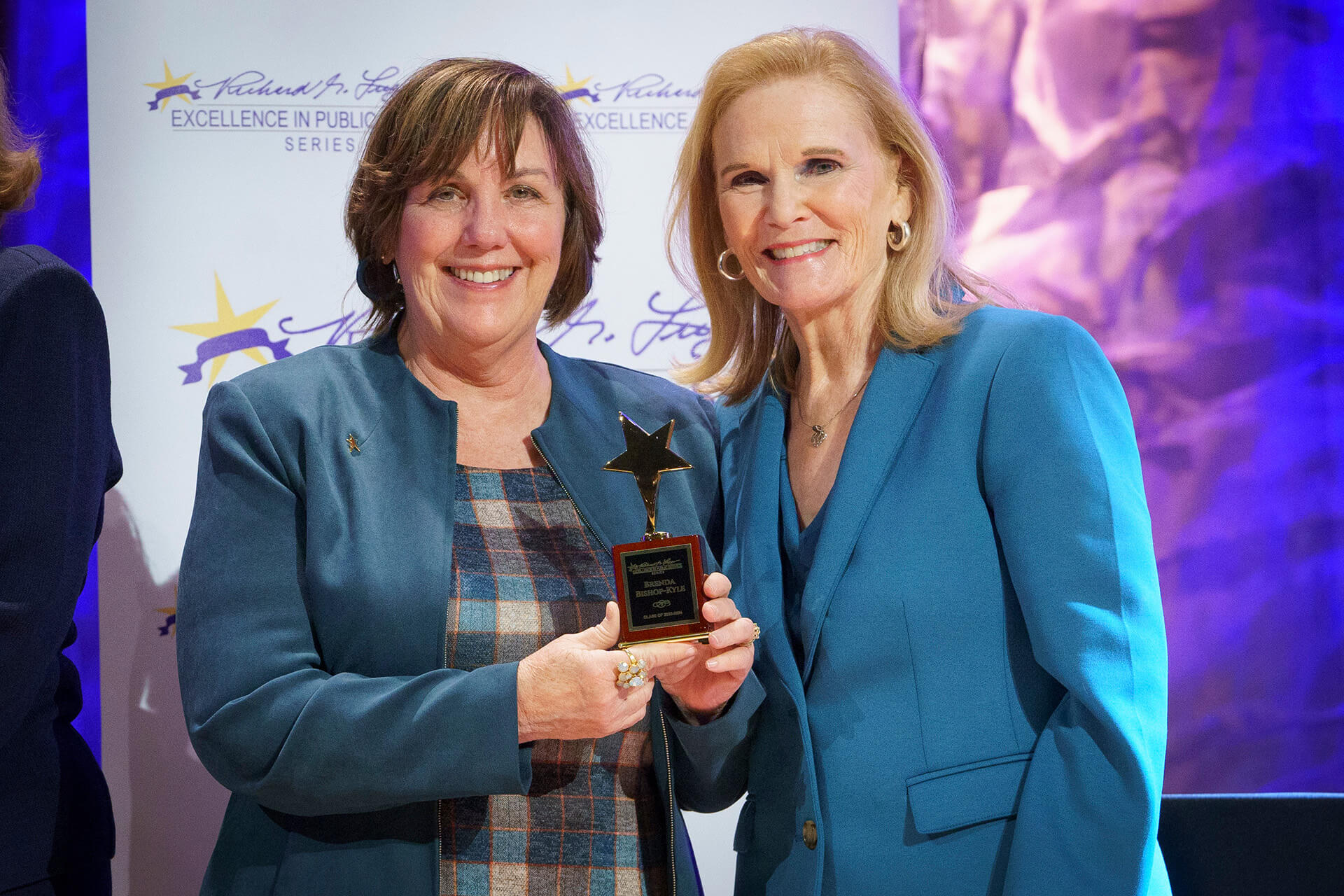 A Lugar Series member smiles as she receives an award