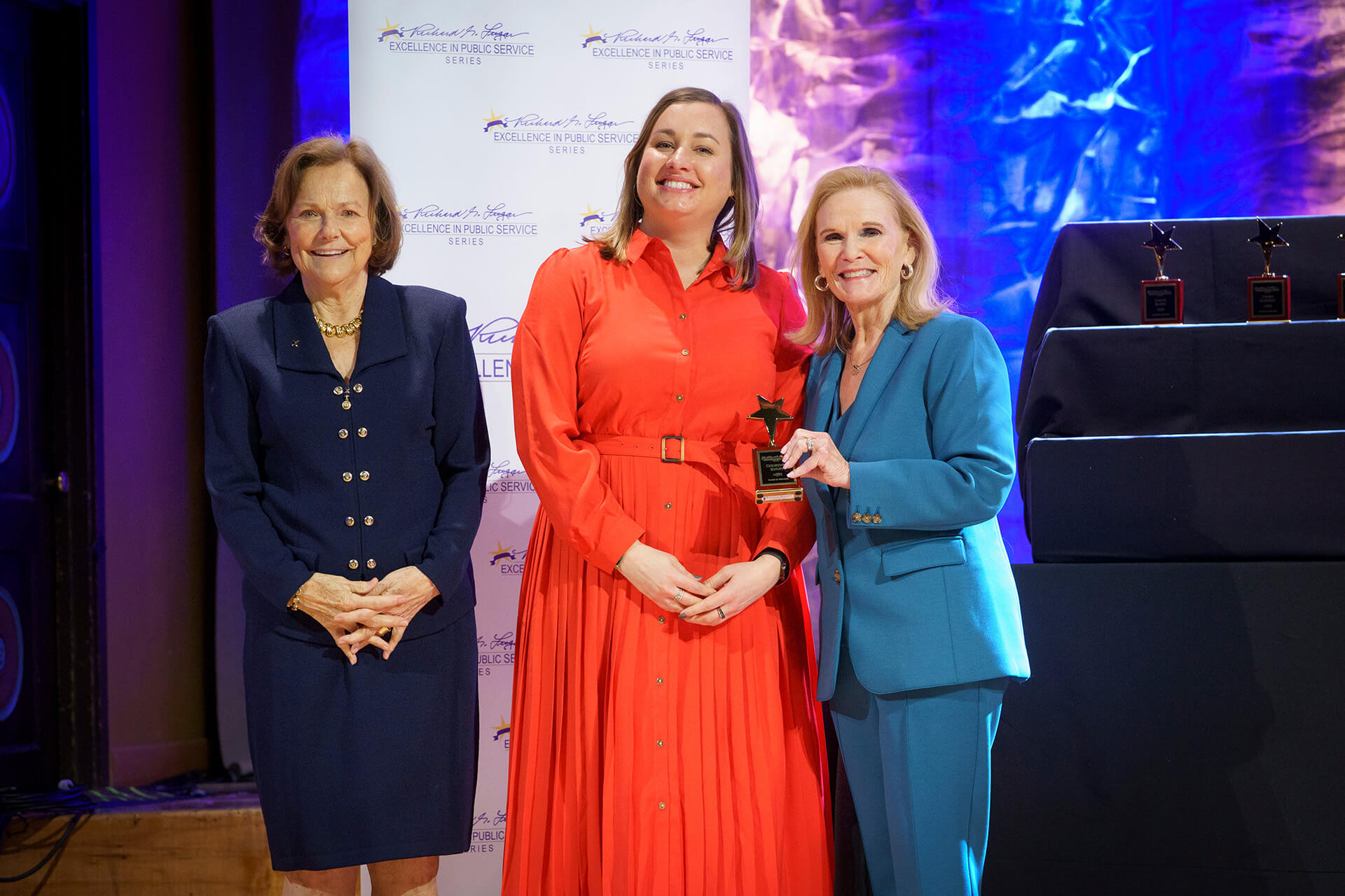 Lugar Series member is handed an award on stage