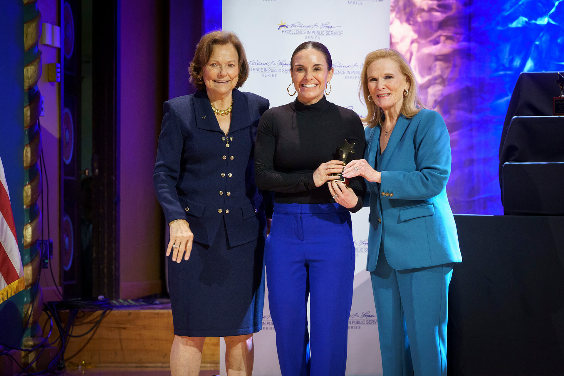 Lugar Series member after receiving an award on stage