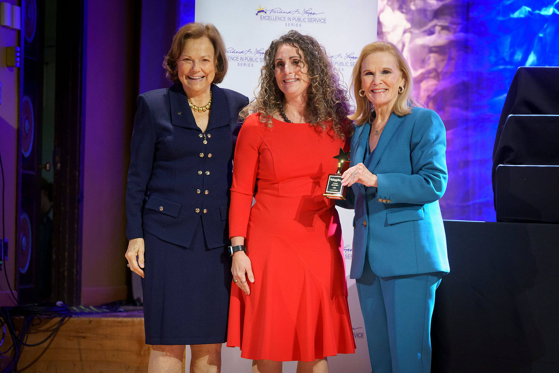 Lugar Series member receives recognition and an award on stage