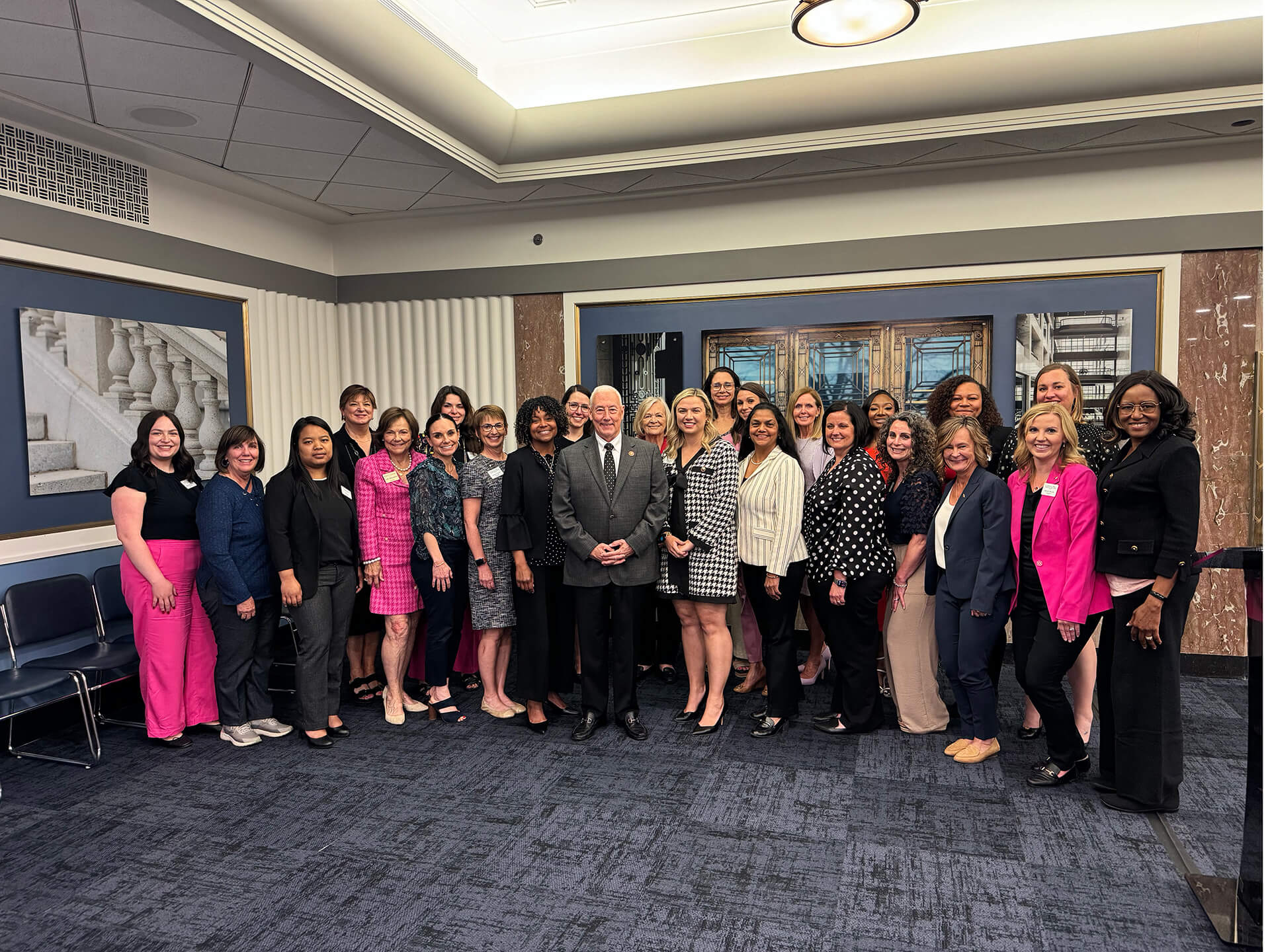 Lugar Series members pose with a speaker at an event