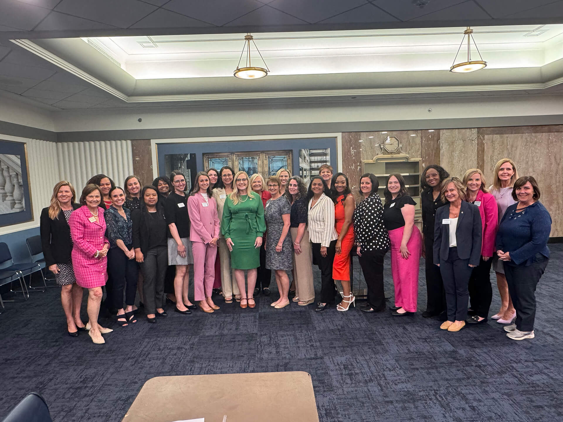 Lugar Series members gather with keynote speaker at an event