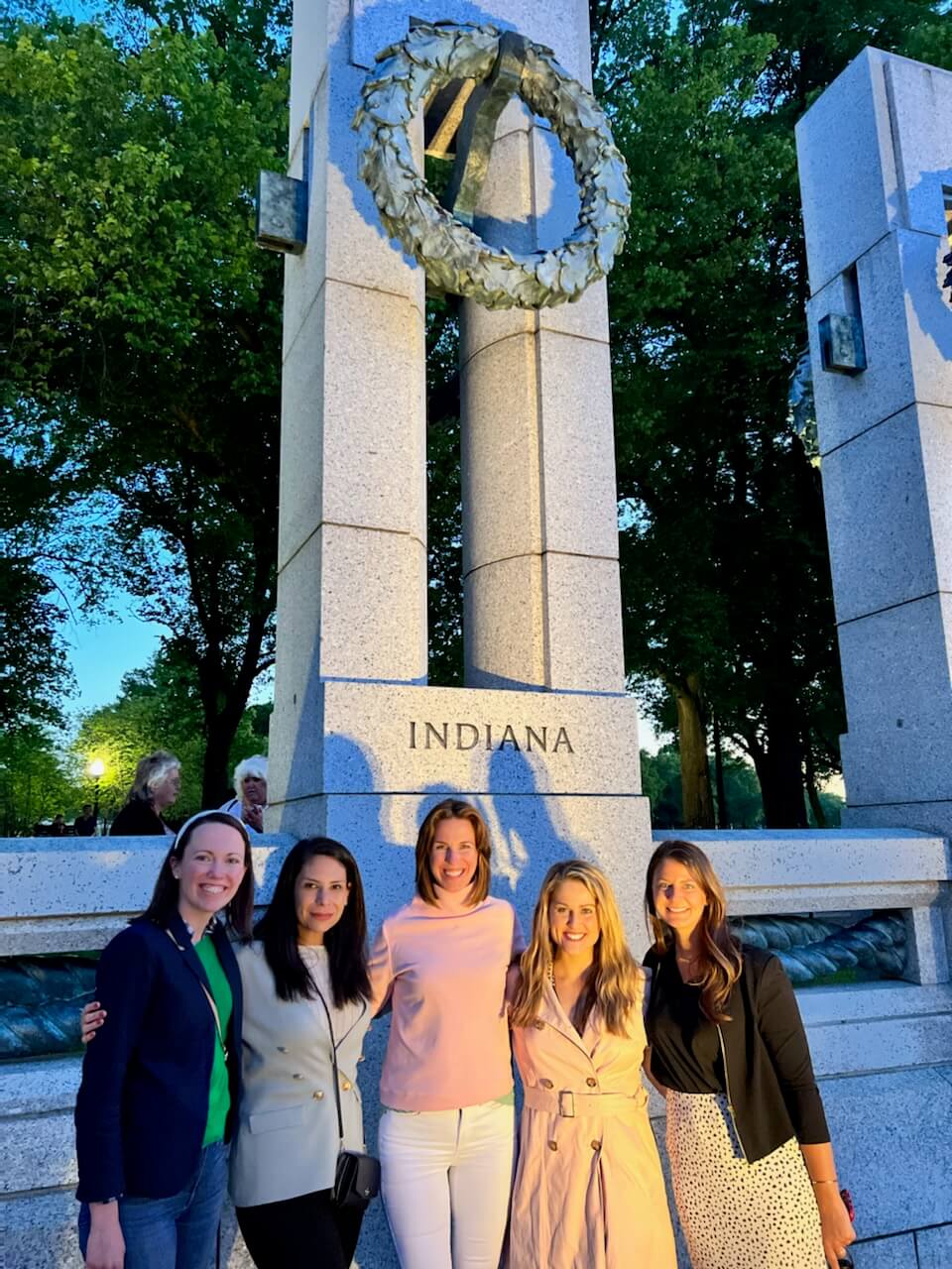 Lugar Series women stand in front of Indiana section of World War II Memorial