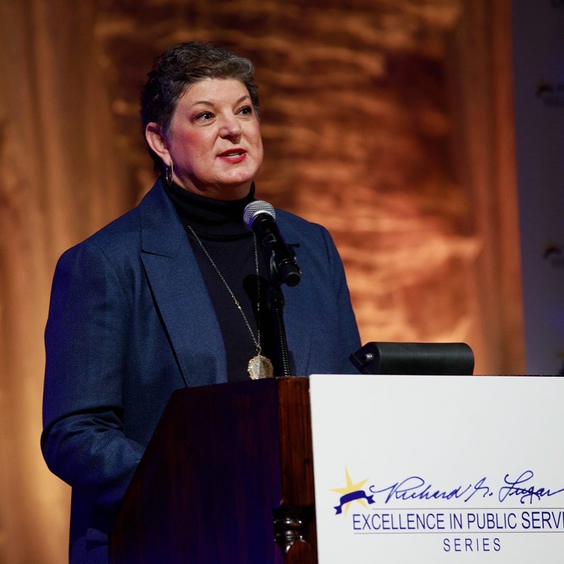 Woman speaks at podium for Lugar Series 2021 event