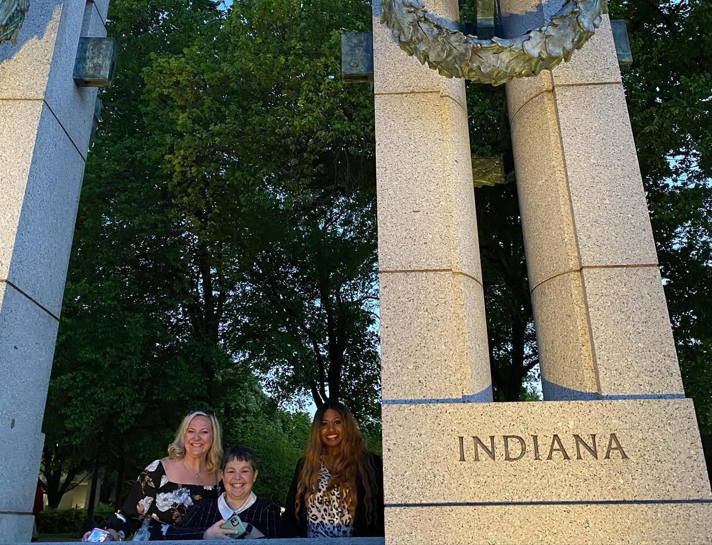 Lugar Series women stand beside Indiana section of World War II Memorial